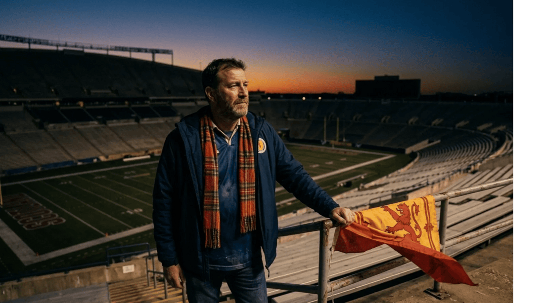 A lone Scotland soccer fan inside an American football stadium at dusk